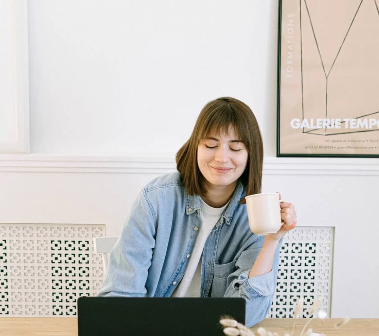 A woman working while having coffee